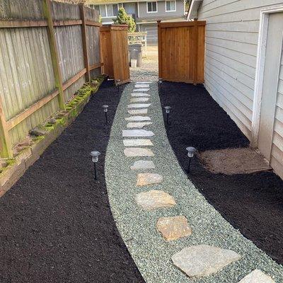 Paving slabs and gravel side yard landscaping