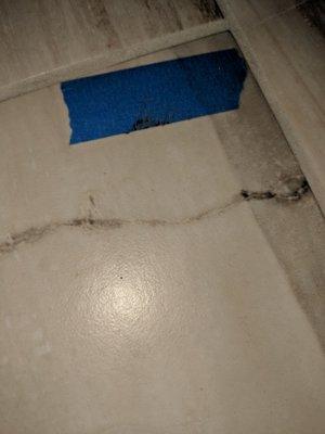 Picture of damaged tile floor.