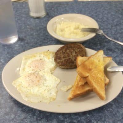 Two over medium, two sausage patties, grits and toast