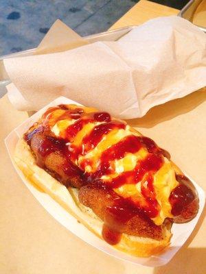 The dog of the month with bacon wrapped dog, honey, barbecue sauce, and (pimento?) cheese! Sweet and salty!