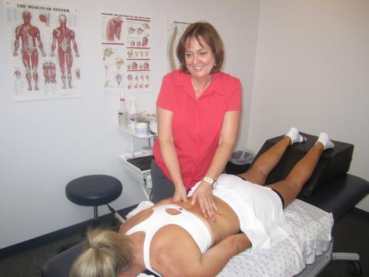 Lisa using manual therapy to help break up soft tissue.