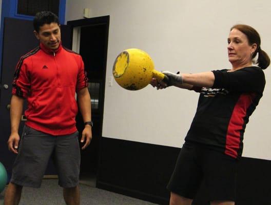 Sergio with a client working on kettlebell swings.  Great job M.!