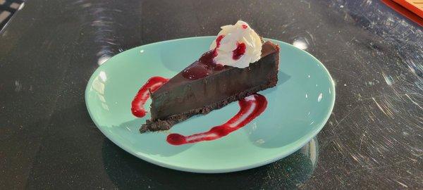 Flourless Chocolate Cake with house made mixed berry sauce.