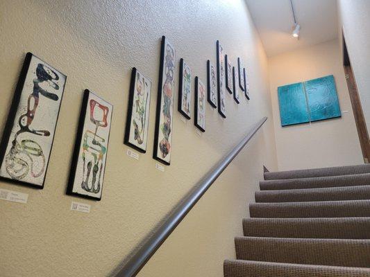 The stairwell leading up to the second floor garnished with Art by a local artist Jennifer Chin