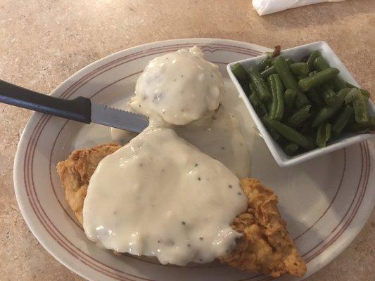 Chicken fried chicken with green beans and mashed potatoes.