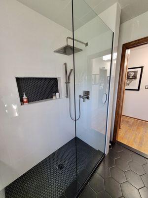 Custom shower with large niche, delta fixtures, and full euro glass