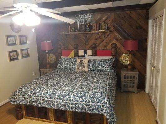 Bedroom also has a chair and tv from the other view.