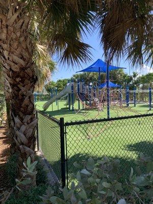 Fenced in playground with multiple levels for all ages.