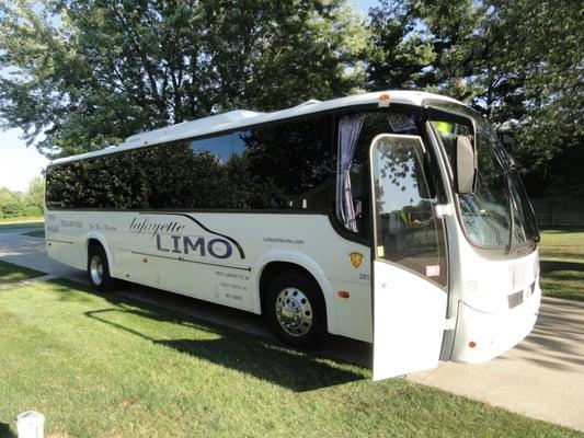 One of our 41-passenger buses, parked outside and ready to pick you up!