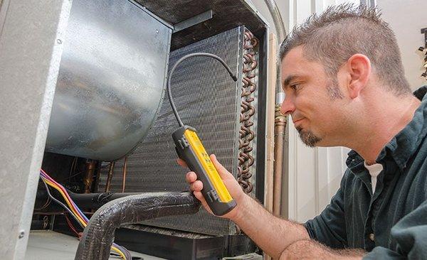 Technician inspecting HVAC equipment