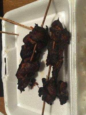 Burnt chicken on a stick. Was told this is what it's supposed to look like.