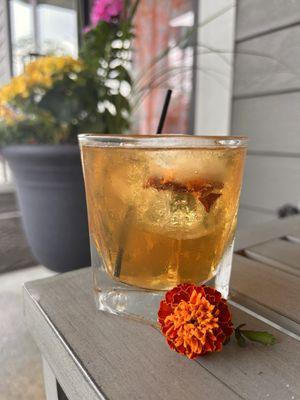 Marigold Press with frozen flower in the ice cube.