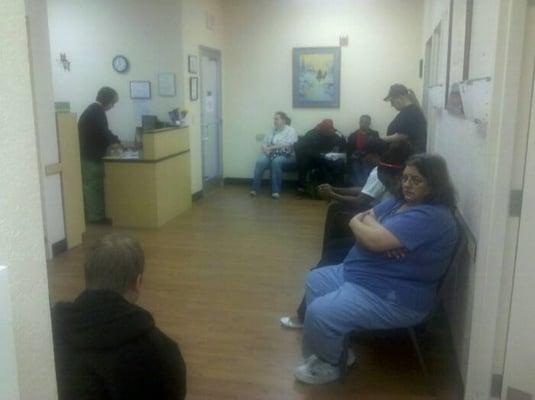 Crowded waiting room, walk-in only, exam rooms full also