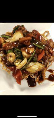 Pan fried noodles One of our most popular dishes. Chicken, beef, and shrimp with vegetables in brown sauce on top of a bed of fried lo mein