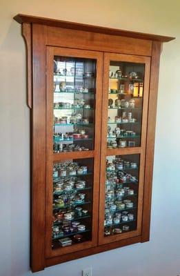 Recessed display cabinet with mirror back and glass shelves.