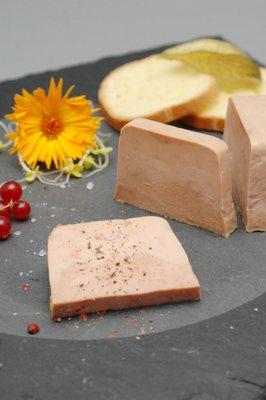 Sliced Foie Gras on a plate served with sea salt.