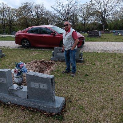 This is me and Pat at our dad's grave site a bit morbid I b realize but we like too party