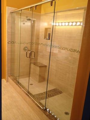 Custom 11' shower enclosure with two sliding panels in the center and a fixed panel on each end.