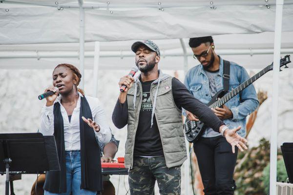 Young worshippers singing at the outdoor church service.