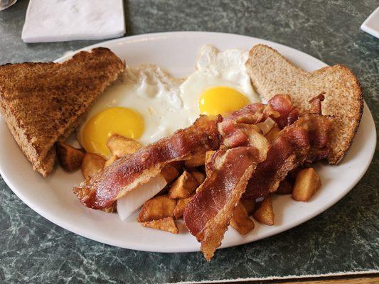 2 eggs with bacon, home fries, and wheat toast