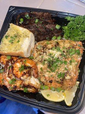 Sockeye Salmon, Rib Eye Steak, Jumbo prawns, over garlic noodles