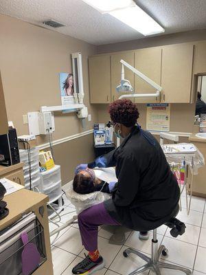 Dental Hygienist providing detail examination and cleaning.