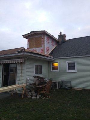 My crew and i cut out the existing roof and began building a very large bathroom.