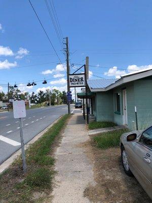 Here's their sign. This is what you see coming from the south. Parking is before the building.