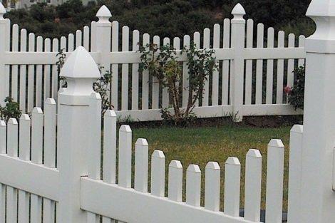 Scalloped vinyl picket fence with gothic caps.