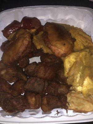 Griot, fried plantains, akra, sausage and patate