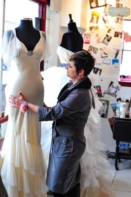 Designer Deedee Vicory working with a dress form at D'Lola Coutre