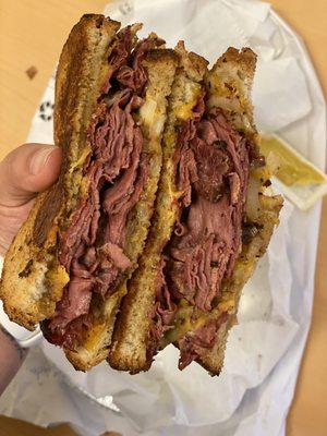 Pastrami, cheddar cheese, onions and mustard on rye