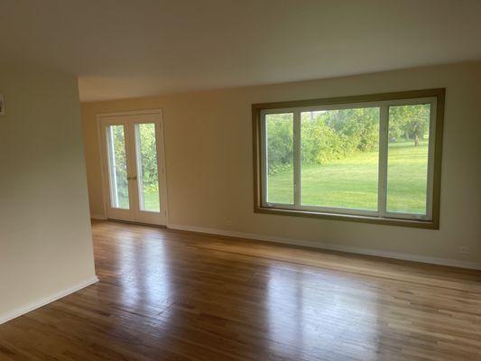 L shaped living room/dining room with French doors