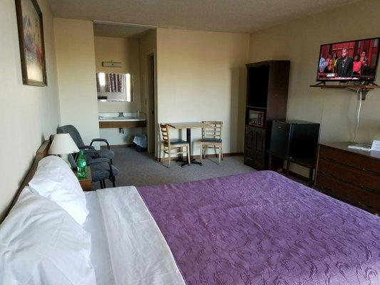 One of our suites. 1 Queen bed, 32" TV, refrigerator, microwave, 2 person dining area.