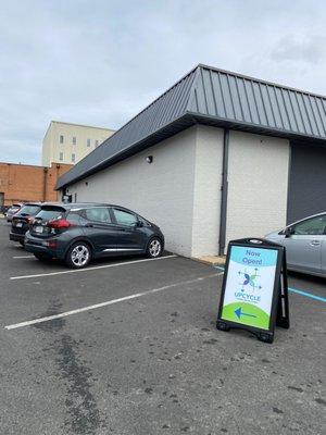 Turn in to the parking lot for The Garden, then turn left at the first break in the buildings.  Park anywhere not labeled "Dominion".