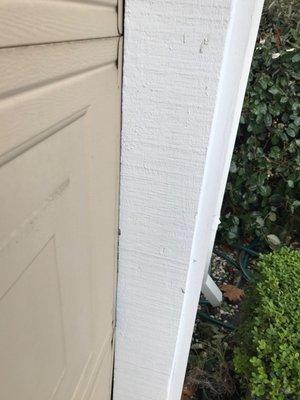 There is no space between the door and the garage wall now because the door frame was bent.