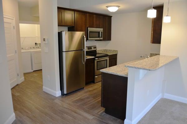 Stainless steel appliances, granite counters, plank wood flooring, and private laundry rooms!