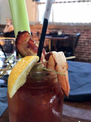 Loaded Bloody Mary. Roasted shrimp, bacon, blue cheese stuffed olives, pickled vegetables, and a celery stick.