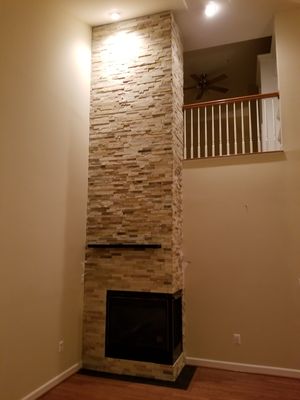 Over the fireplace natural stone (stack stone) installation done in Ellicott City, MD.