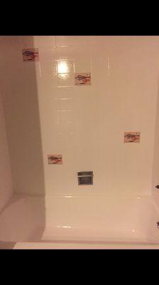 Formerly all-pink shower and tub surround now white, but keeping the original accent tiles