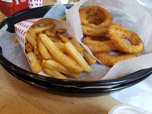 Very large onion rings and fries are a golden brown perfection