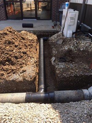 6 inch drain line tapped into 8 inch main line to catch rainwater from guttering system.