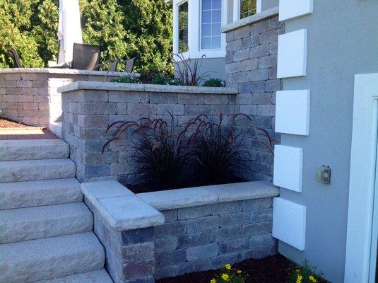 Terrace with Unilock wall block and coping.