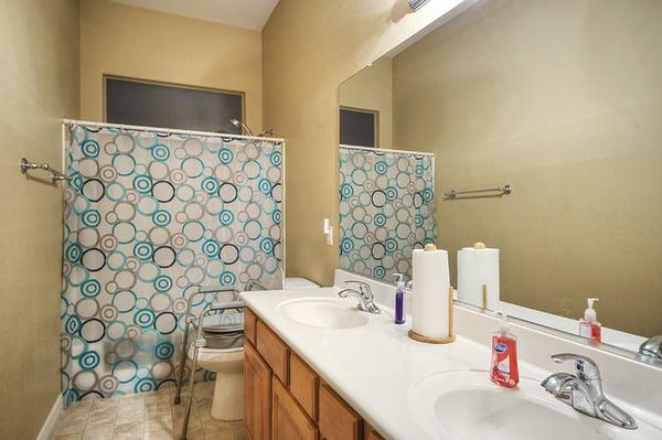 A Double Sink Bathroom with Grab Bars for Safety.