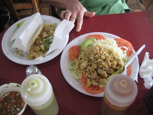 chicken taco (left) and chicken salad (right) and 2 bottles of salsa