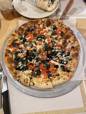 Greek pizza with olives just on half