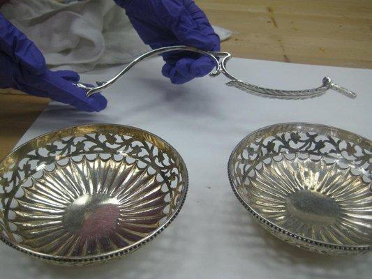 A tarnished and unpolished silver bowl (left) and a polished silver piece (right). There is a visible difference in cleanliness and color.