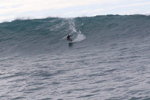 Tow in session at an outer reef on the north shore