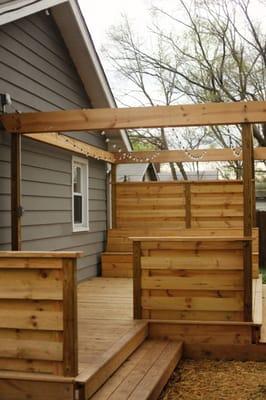 This custom deck and privacy barrier create a beautiful and tranquil outdoor living space.