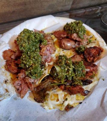 A variety of sausages available for tacos or sandwiches. Delicious chimichurri sauce adds great flavor. At Smog City on a Sunday night.